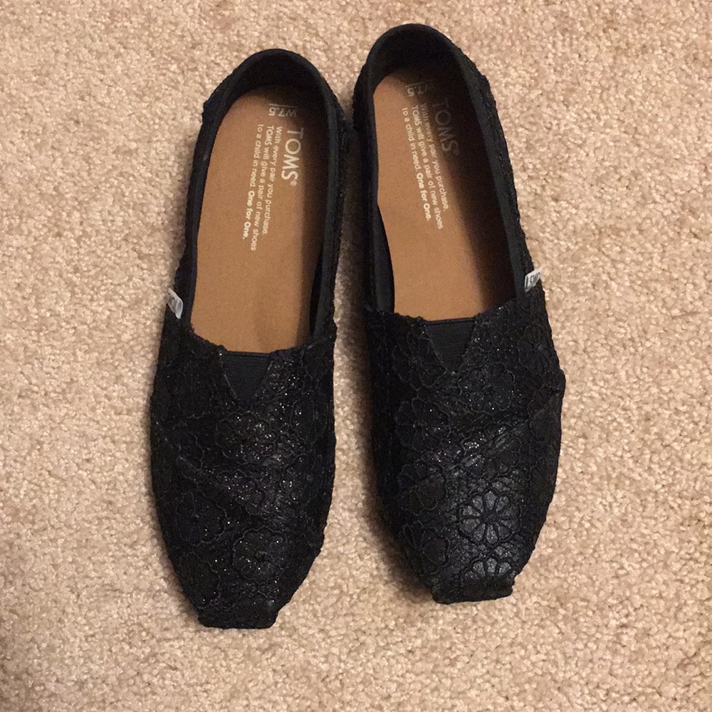 TOMS black glittering lace shoes.